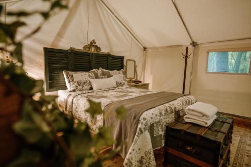a bedroom with a bed in a tent at Station Chene rouge in Albert Mines