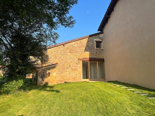 a house with a grass yard next to a building at Studio 25m2 neuf in Châtillon