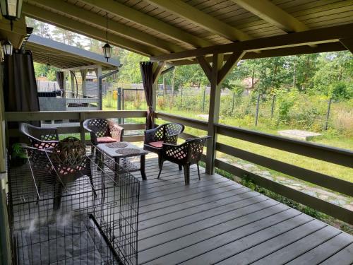 a screened in porch with chairs and a table at Siemianówka in Siemiany