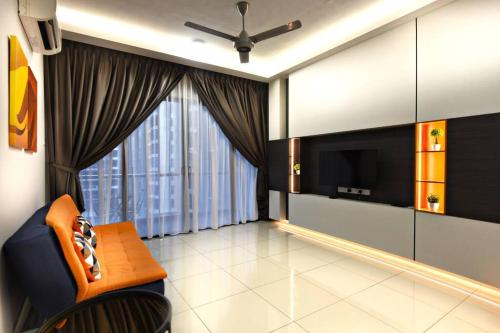 a living room with a tv and a couch and a ceiling fan at InStay Atlantis - The Orange in Melaka