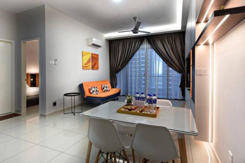 a living room with a table and chairs and a couch at InStay Atlantis - The Orange in Melaka
