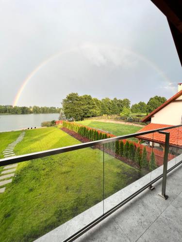 a view of a rainbow from the balcony of a house at Lake House Borowe in Borowe