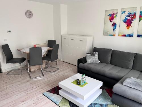 a living room with a couch and a table at Ferienwohnung "Lilly" inklusive Nutzung W-Lan Bettwäsche und Handtücher in Annaberg-Buchholz