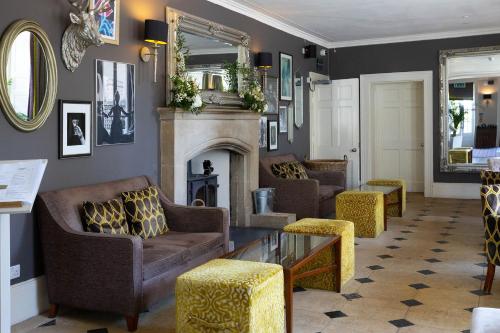 a living room with couches and a fireplace at Barton Hall Hotel & Spa in Kettering