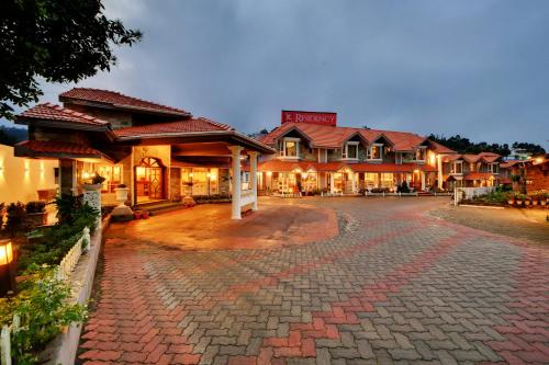 a cobblestone street in front of a hotel at JC Residency in Kodaikānāl