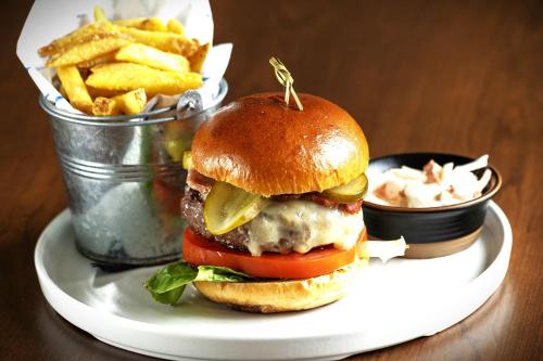 a cheeseburger on a plate with french fries at Barton Hall Hotel & Spa in Kettering