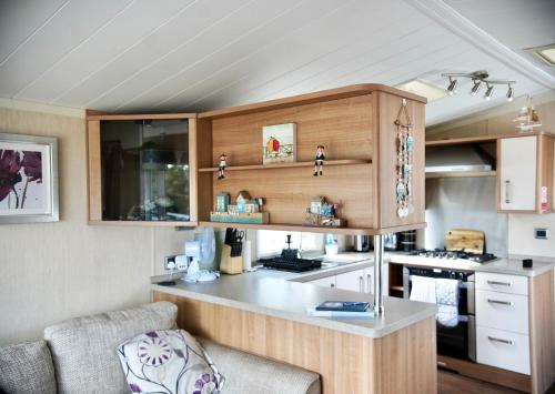 a kitchen with a counter in a caravan at Sea Breeze Cabin in Poole