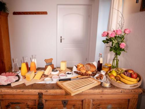 a table with cheese and other foods on it at Hotel Baders Krone in Laupersdorf