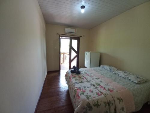 Una cama o camas en una habitación de Pousada Tupaiú