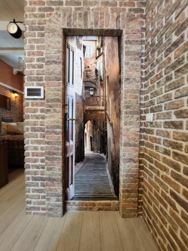 an alley way in an old building with a brick wall at THE IMPERIAL SUITE e THE BRICKS in Rome
