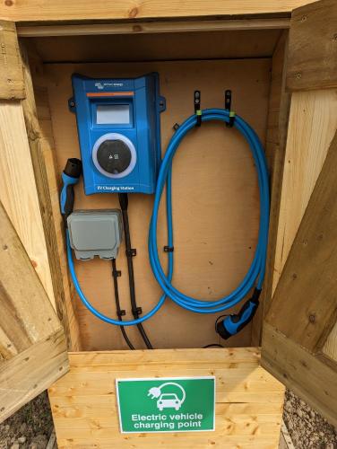 a wooden box with a machine and a sign in it at Gosling Lodge in Durham