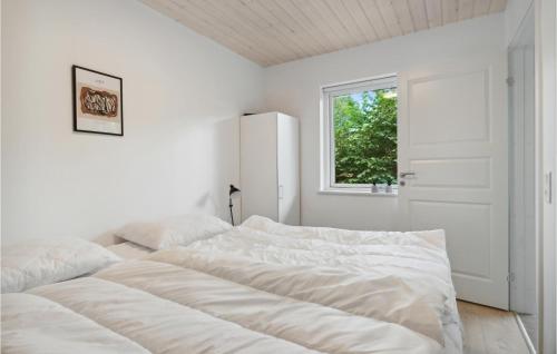 a white bedroom with a bed and a window at Stunning Apartment In Slagelse With Kitchen in Slagelse