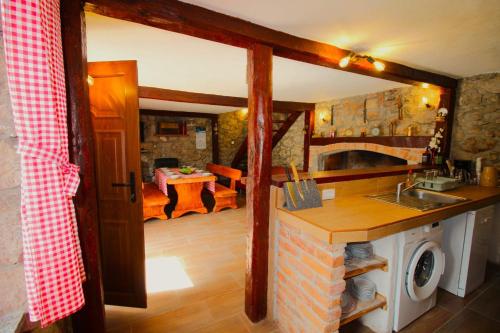 a kitchen with a sink and a stove at Kuća za odmor Krasnica in Novi Vinodolski