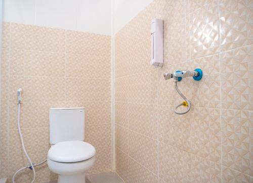 a bathroom with a toilet and a shower at Jo&Jo Hostel in Bandar Lampung