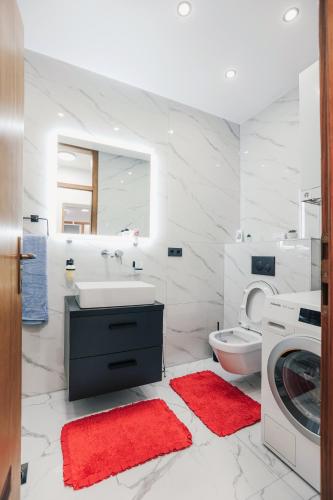 a white bathroom with a sink and a toilet at Apartman STRONG in Slavonski Brod