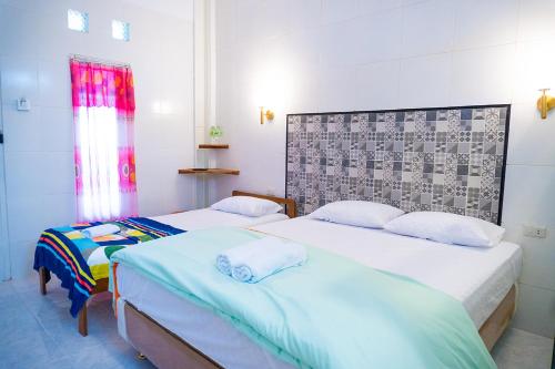 a room with two beds and a window at Jo&Jo Hostel in Bandar Lampung