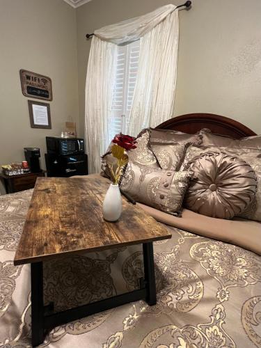 a bedroom with a bed with a table on it at Opus House Historic Natchitoches in Natchitoches