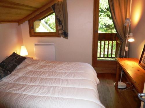 a bedroom with a white bed and a window at Appartement Méribel, 4 pièces, 8 personnes - FR-1-411-71 in Les Allues