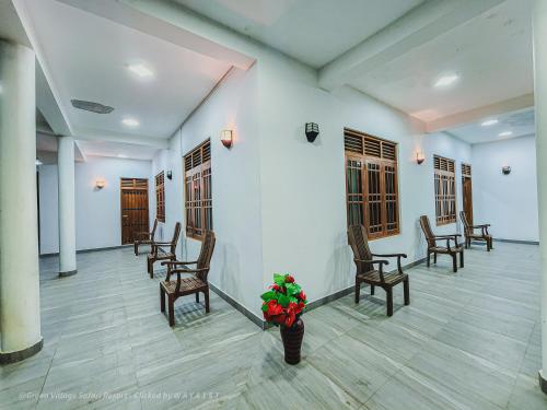 a waiting room with chairs and a vase of flowers at Green Village Safari Resort in Udawalawe