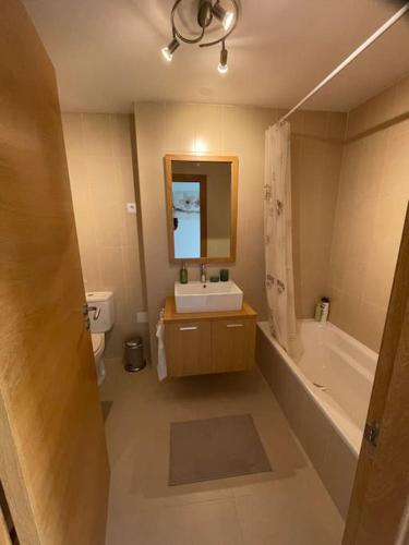 a bathroom with a sink and a tub and a toilet at Casa Calida in Sucina