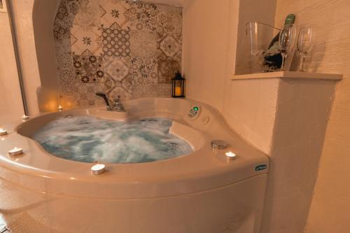 a bathroom with a jacuzzi tub in the corner at Suite Pietra Bianca - Relax & SPA in Martina Franca
