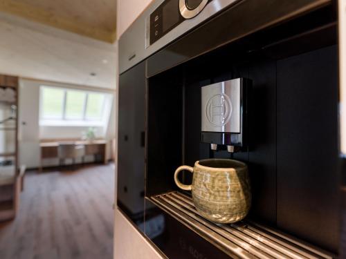 a coffee cup is sitting in a microwave oven at Villa Himmlgassl Private Spa in Zellbergeben