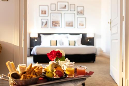 a tray of food on a table in a hotel room at Palmyra Golf Hotel & Spa in Cap d'Agde