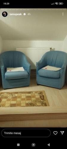 a living room with two blue couches in a room at Zori De Zi 