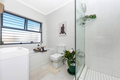 biała łazienka z toaletą i prysznicem w obiekcie Urban Oasis - 3 Bedroom Home w mieście Sandton