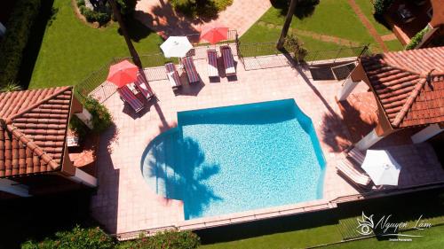 an overhead view of a swimming pool in a house at Palmyra Golf Hotel & Spa in Cap d'Agde