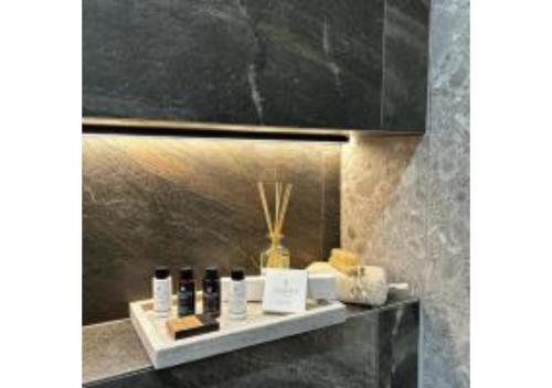 a shelf with cosmetics on it in a room at On The Sea Suite&Spa in Methana