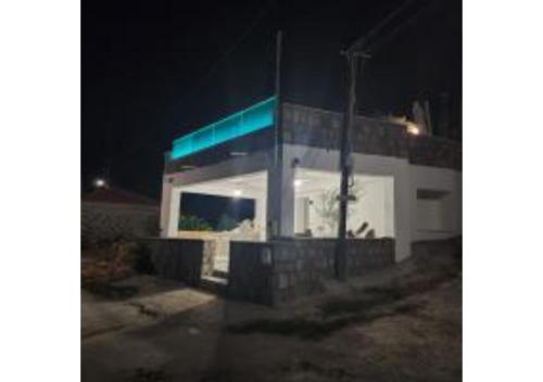 a gas station is lit up at night at On The Sea Suite&Spa in Methana