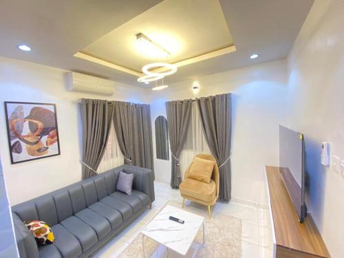a living room with a couch and a chair at Dlulus Ventures Mini Flat apartment sabo in Lagos