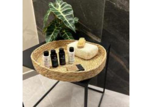 a bathroom with a round sink with towels and a plant at On The Sea Suite&Spa in Methana