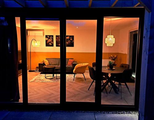 a living room with a table and a couch at Luxe Natuurhuis Veluwe Home 'De Bosvogel' in Ermelo
