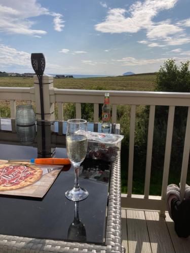 a glass of wine sitting on a table on a balcony at Carnoustie 24 - Turnberry Holiday Park - short walk to beach in Girvan