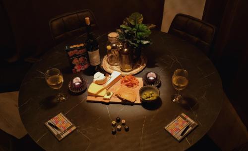 a table with wine glasses and food on it at Luxe Natuurhuis Veluwe Home 'De Bosvogel' in Ermelo