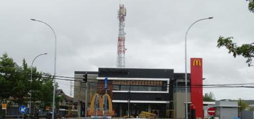 a large building with a mcdonalds with a crane at Banda Aceh Batoh Homestay - private - fits up to 8 persons in Banda Aceh
