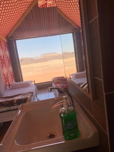 a bathroom with a sink and a view of the desert at wadi rum land mars in Wadi Rum