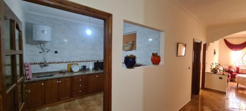 a room with a kitchen with a large window at Plage et montagne near Tanger in Tangier
