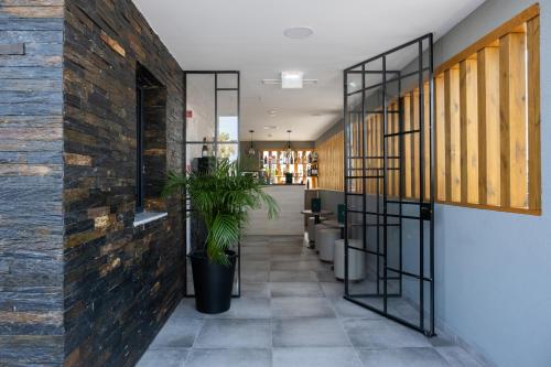 a lobby of a building with a plant at Ria Formosa Guest House in Faro