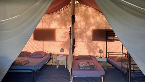 a room with two beds in a tent at TENTE LODGE la Plage AUTET in Autet