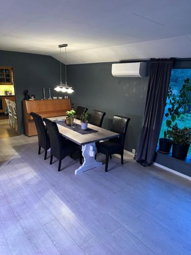 a dining room with a table and black chairs at Sagavang in Trondheim