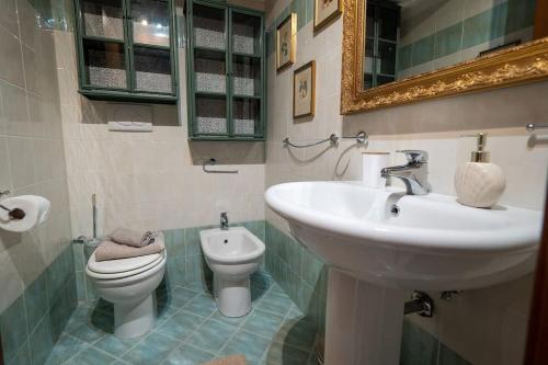 a bathroom with a sink and a toilet and a mirror at [Apartment near Perugia] - Free Parking & A/C in Badiola