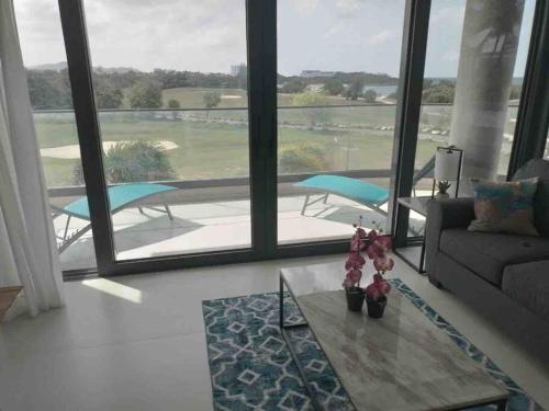 a living room with a couch and a table at Luxury Oceanview 1BR on beach in Cupecoy