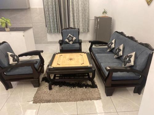 a living room with two chairs and a coffee table at RASA - The Ganges Rishikesh, Ganga Bhumi Apartment in Rishīkesh