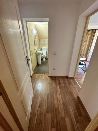a hallway with a bathroom with a sink and a toilet at Casa "La padure" in Bran