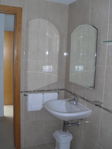 a bathroom with a sink and a mirror at Hotel Brisa del Mar in O Grove