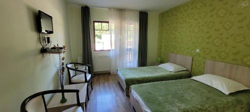 Postel nebo postele na pokoji v ubytování Complex Turistic Perla Trascaului