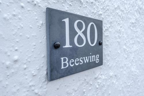 a sign on the side of a building with at Beeswing, a Victorian Gem in Biggar in Biggar
